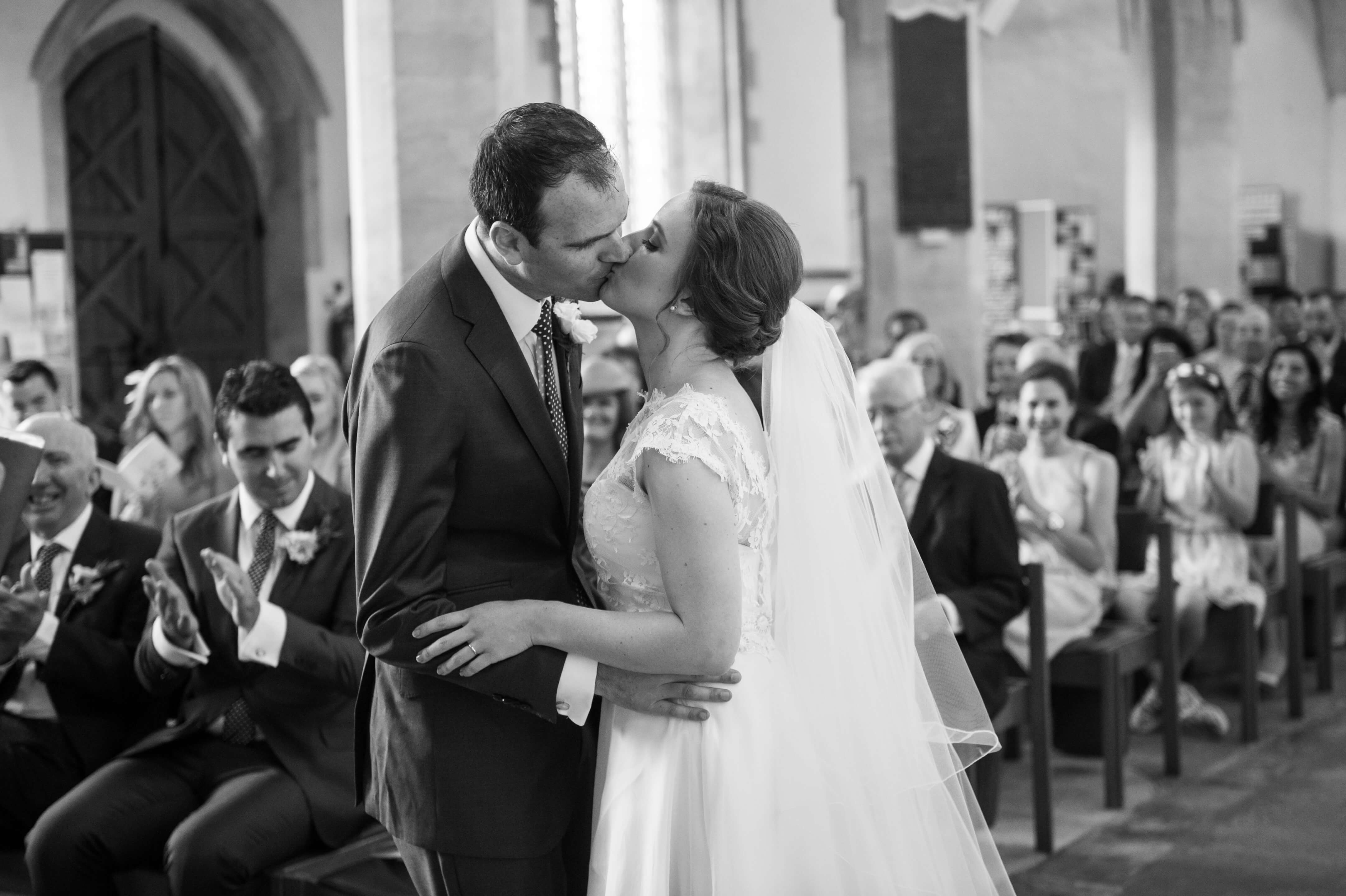 A bride and groom kissing just after they have been declared married